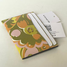 Load image into Gallery viewer, Floral patterned cardholder with Coach tag on a light background
