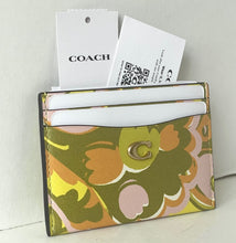 Load image into Gallery viewer, Floral patterned cardholder with Coach branding on a light gray background