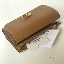 Load image into Gallery viewer, Brown leather wallet with gold accents on a white background