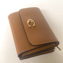 Load image into Gallery viewer, Brown leather wallet with a gold emblem on a white background