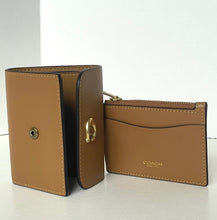 Load image into Gallery viewer, Brown leather wallet with gold accents on a white background