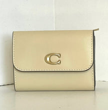 Load image into Gallery viewer, Beige wallet with a gold logo on a white background