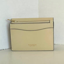 Load image into Gallery viewer, Beige Coach wallet on a light gray surface with a white background