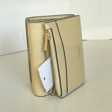 Load image into Gallery viewer, Beige wallet with gold zipper and Coach branding on a light background