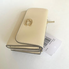 Load image into Gallery viewer, Beige wallet with gold clasp on a white background