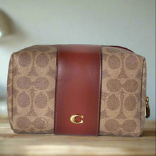 Load image into Gallery viewer, Coach handbag with brown leather stripe and logo on a white background