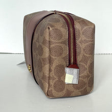 Load image into Gallery viewer, Brown patterned toiletry bag with a gold zipper on a white background