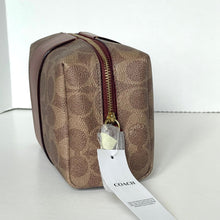 Load image into Gallery viewer, Coach toiletry bag with a visible brand tag on a white background