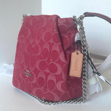 Load image into Gallery viewer, Red handbag with a chain strap and visible brand tag on a white background