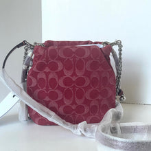Load image into Gallery viewer, Red patterned handbag with silver chain strap on a white surface