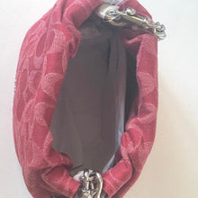 Load image into Gallery viewer, Red textured fabric with metal clasps on a white background