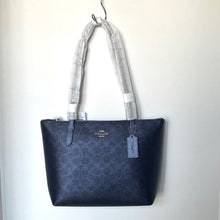 Load image into Gallery viewer, Blue tote bag with a visible brand tag on a white background