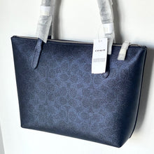 Load image into Gallery viewer, Blue Coach handbag with a visible tag on a white background