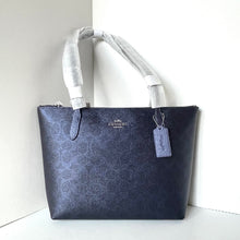Load image into Gallery viewer, Navy blue handbag with a visible brand tag on a white background