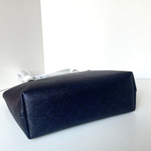 Load image into Gallery viewer, Black leather clutch bag on a white surface with a white background