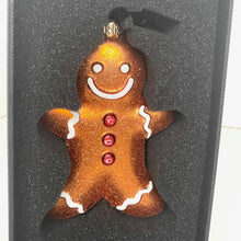 Load image into Gallery viewer, Gingerbread man ornament with a smile on a black background