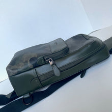 Load image into Gallery viewer, Green leather bag with a visible brand logo on a white surface