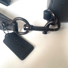 Load image into Gallery viewer, Black Coach keychain attached to a leather bag on a white surface
