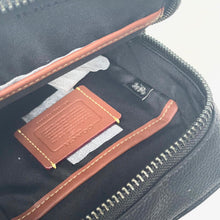 Load image into Gallery viewer, Close-up of a black bag with brown leather card holder and stitching details.