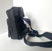 Load image into Gallery viewer, Black leather crossbody bag with a strap on a white background