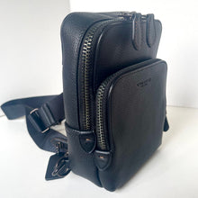 Load image into Gallery viewer, Black leather crossbody bag with visible brand logo on a white background