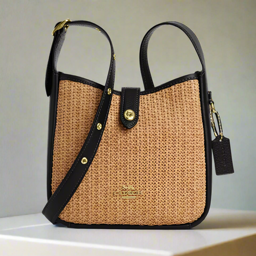 Woven handbag with black accents on a white background