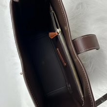 Load image into Gallery viewer, Brown leather handbag with a zipper on a white background