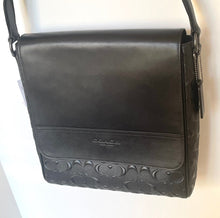 Load image into Gallery viewer, Black leather bag with brand logo on a white background