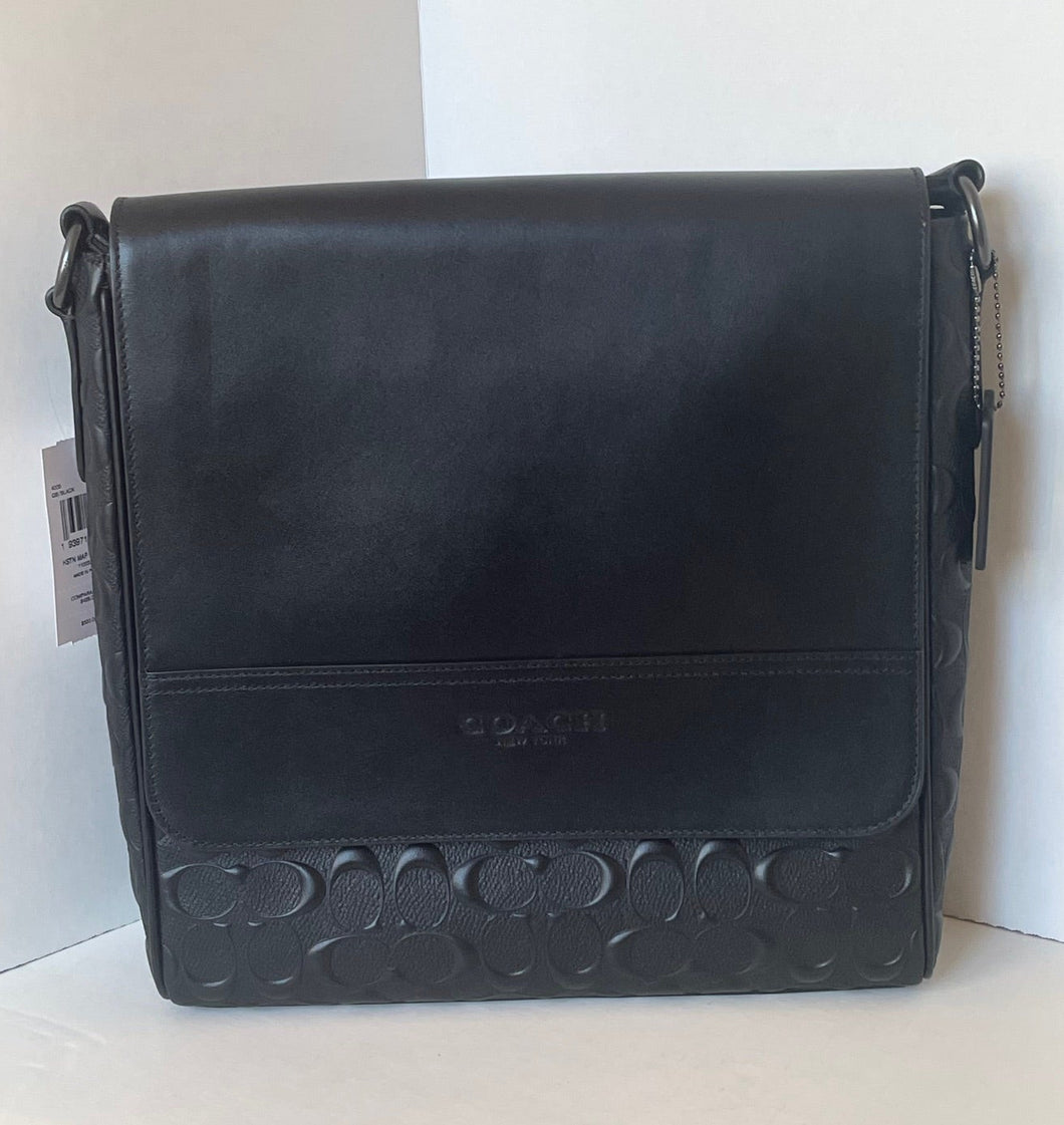 Black leather Coach bag on a white background