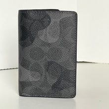 Load image into Gallery viewer, Black leather wallet with a subtle pattern on a white background