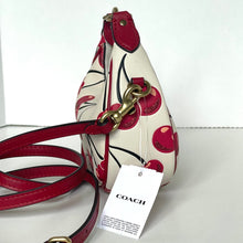 Load image into Gallery viewer, Coach handbag with floral design and red strap on a white background