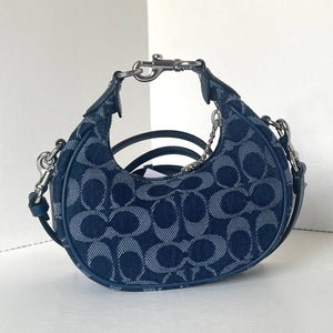 Blue handbag with a pattern on a white background