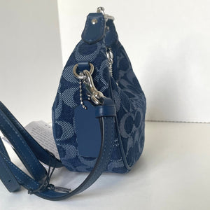 Blue patterned handbag with a strap on a white background