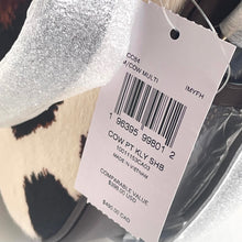 Load image into Gallery viewer, Close-up of a product tag with a barcode and text on a textured surface.