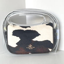 Load image into Gallery viewer, Coach pouch with cow print design in clear packaging on a white background