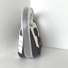 Load image into Gallery viewer, Designer handbag with a cow print pattern on a white background