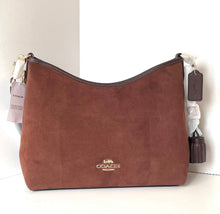 Load image into Gallery viewer, Brown handbag with Coach logo on a white background