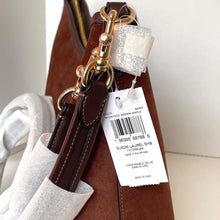 Load image into Gallery viewer, Brown leather handbag with gold accents and a visible tag on a neutral background