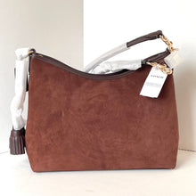 Load image into Gallery viewer, Brown handbag with a visible Coach tag on a white background