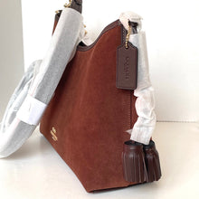 Load image into Gallery viewer, Brown leather handbag with a tag on a white background