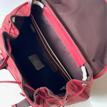 Load image into Gallery viewer, Red backpack with open front compartment showing interior details.
