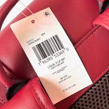 Load image into Gallery viewer, Red glove with a price tag displaying a barcode and text.