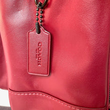 Load image into Gallery viewer, Close-up of a red Coach handbag with a tag.