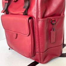 Load image into Gallery viewer, Red leather backpack with a visible brand tag on a white background