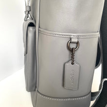Load image into Gallery viewer, Gray backpack with a visible brand tag on a white background
