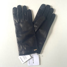 Load image into Gallery viewer, Pair of black leather gloves with Coach tags on a white background