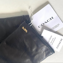 Load image into Gallery viewer, Black leather glove with Coach tag on a light background