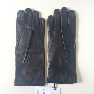 Pair of black leather gloves with a visible brand tag on a white background