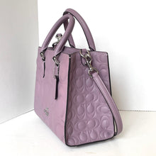 Load image into Gallery viewer, Purple handbag with embossed logo on a white background