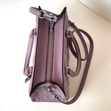 Load image into Gallery viewer, Purple handbag with silver zippers on a light beige background